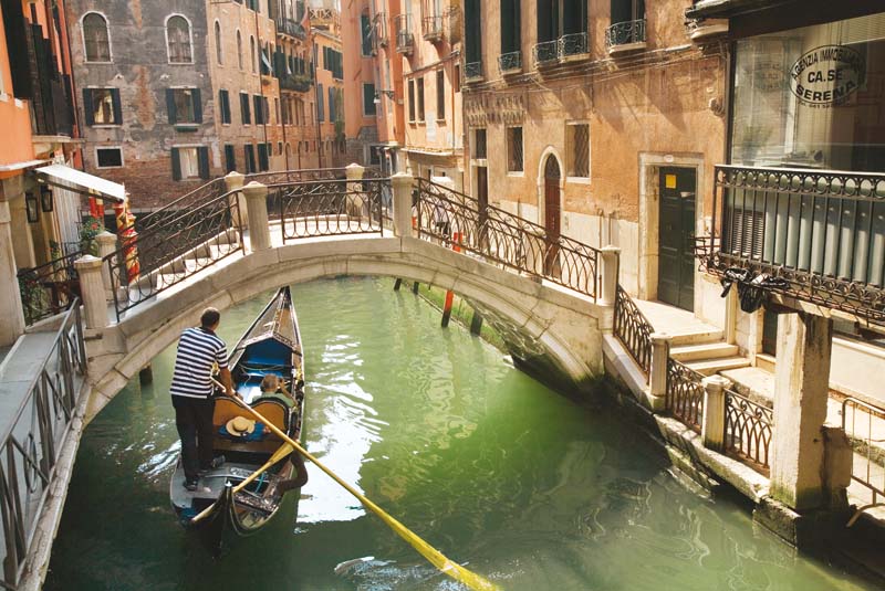 sweet serenade a gondolier steering his gondola along one of the azure canals of the fantasy like city photo courtesy wikimedia