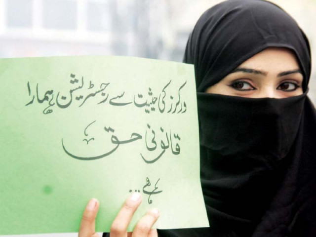 a woman holds a sign in support of her demands photo abid nawaz express a woman holds a sign in support of her demands photo abid nawaz express
