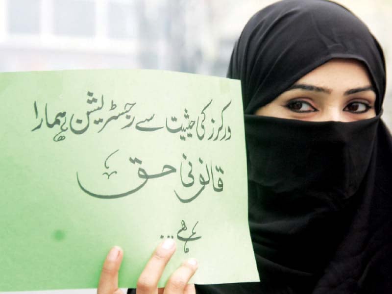 a woman holds a sign in support of her demands photo abid nawaz express