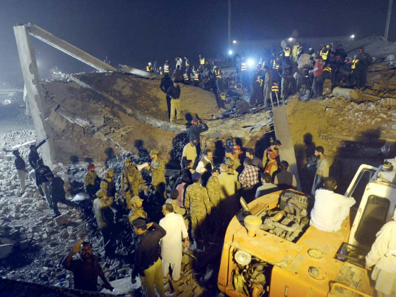 rescuers search for survivors in the rubble of the factory photo afp
