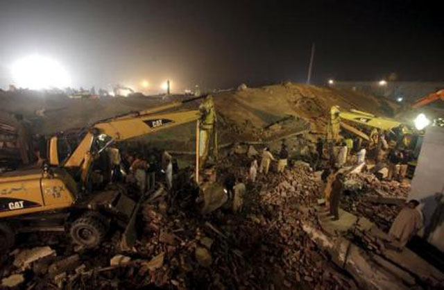 rescue workers search for survivors after a factory collapsed near lahore on november 4 2015 photo reuters