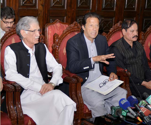 pti chief imran khan c flanked by k p chief minister pervez khattak l addressing a press conference in peshawar on tuesday photo nni pti chief imran khan c flanked by k p chief minister pervez khattak l addressing a press conference in peshawar on tuesday photo nni
