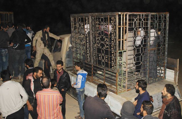 syrians are seen inside a cage in douma the largest opposition stronghold on the outskirts of damascus on october 31 2015 as it has been reported that a major syrian rebel group is using dozens of captives in metal cages as quot human shields quot photo afp