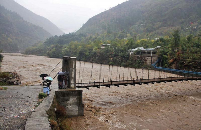 people stand near a bridge on khan khwar river in shangla which is in high flood photo online people stand near a bridge on khan khwar river in shangla which is in high flood photo online