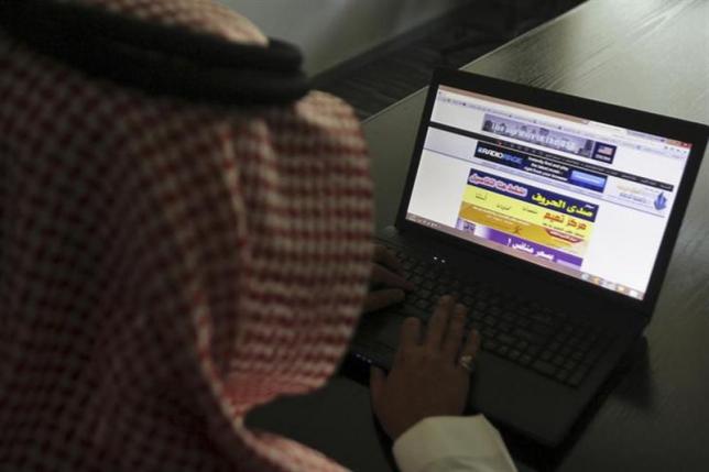 a saudi man explores a website on his laptop in riyadh photo reuters