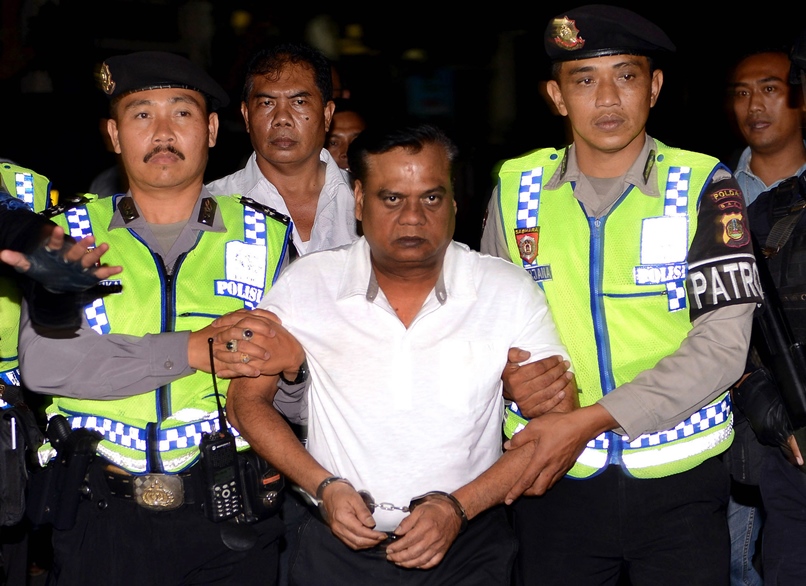 indonesian police escort indian national rajendra sadashiv nikalje c from bali police headquarters on november 5 2015 photo afp