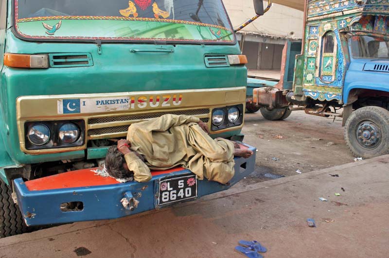 a driver sleeps on the vehicle for lack of work during a strike most of the construction sites in karachi have not been receiving any gravel since four days as around 10 000 trucks have stopped operations photo file