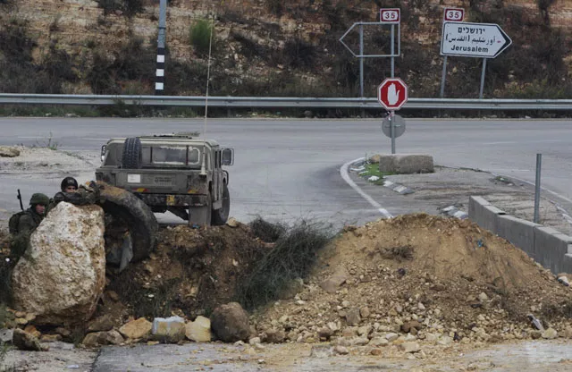 israeli soldiers stand guard at the main northern entrance of the west bank city of hebron on november 7 2015 photo afp israeli soldiers stand guard at the main northern entrance of the west bank city of hebron on november 7 2015 photo afp
