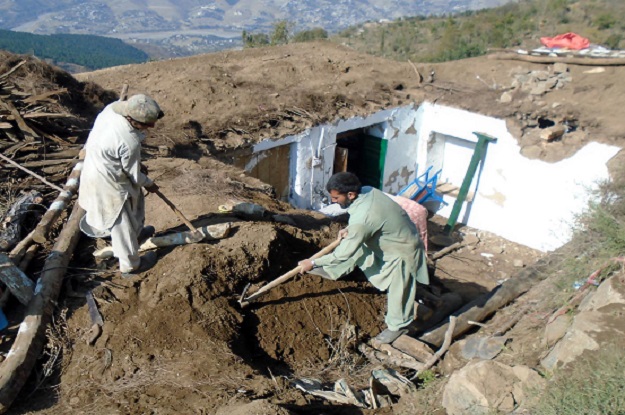 people rebuilding their houses after the recent earthquake photo inp