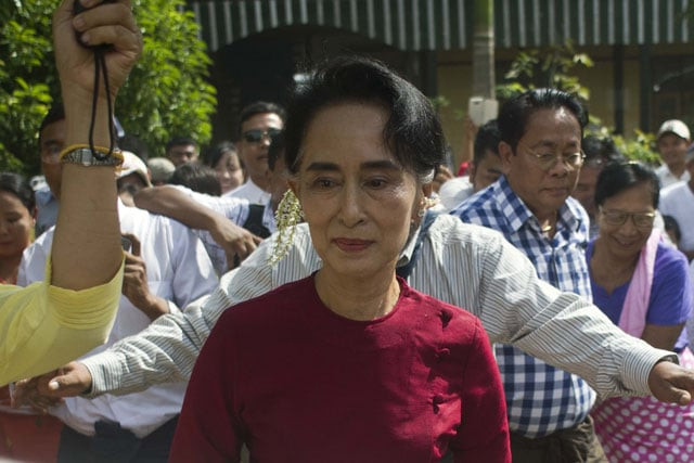 myanmar opposition leader and head of the national league for democracy nld aung san suu kyi c visits a polling station in kawhmu township yangon on november 8 2015 photo afp