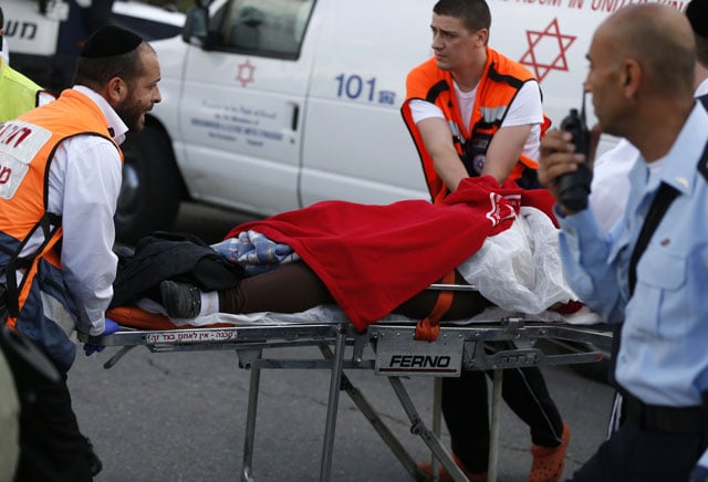 israeli medics push a stretcher carrying a palestinian woman who reportedly stabbed an israeli security guard and was then shot by him near the west bank settlement of beitar illit on november 8 2015 photo afp