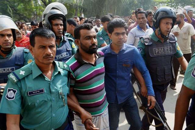 bangladesh police escort a suspect c in a high profile murder case involving the brutal killing of a child at a court in khulna on november 8 2015 photo afp