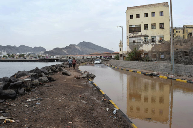 yemenis walk along a flooded street in aden on november 3 2015 following a tropical cyclone that has slammed into the country photo afp