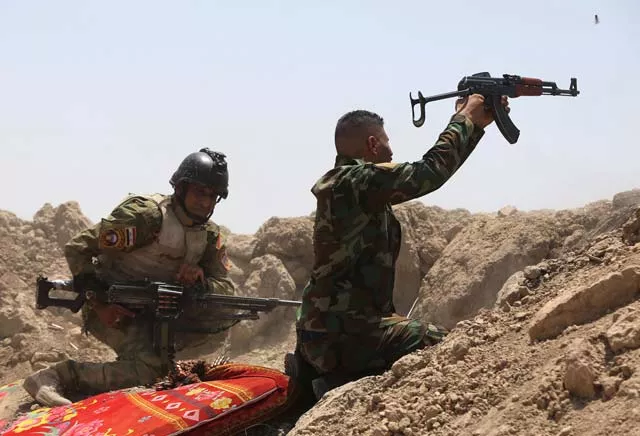 iraqi soldiers fire towards islamic state is group positions in the garma district of anbar province west of the iraqi capital baghdad on may 19 2015 photo afp iraqi soldiers fire towards islamic state is group positions in the garma district of anbar province west of the iraqi capital baghdad on may 19 2015 photo afp