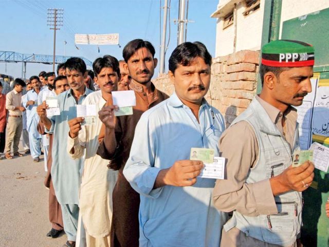 men queue up outside a polling station in sukkur to vote photo naeem ghouri express