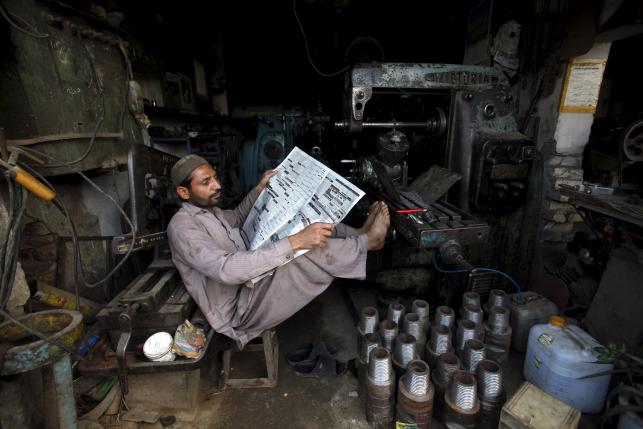 a worker takes a break from his work during a power cut at a workshop on the outskirts of peshawar pakistan november 5 2015 photo reuters