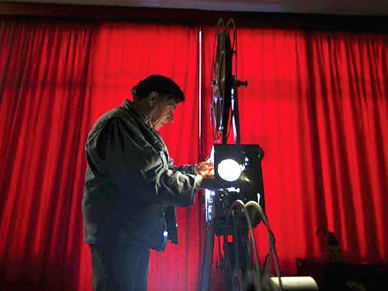 feliciano checks his projector before showing a film in monforte portugal on may 16 2015 photo reuters