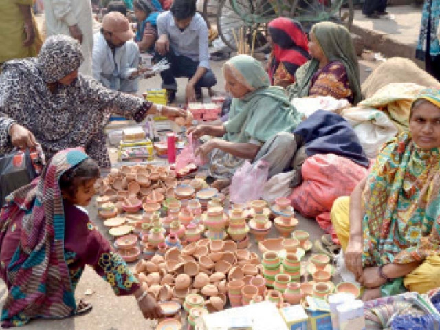 female vendors sell earthen lamps bangles and other items ahead of diwali these lamps are lit and then floated into the water of a river or sea photo inp female vendors sell earthen lamps bangles and other items ahead of diwali these lamps are lit and then floated into the water of a river or sea photo inp