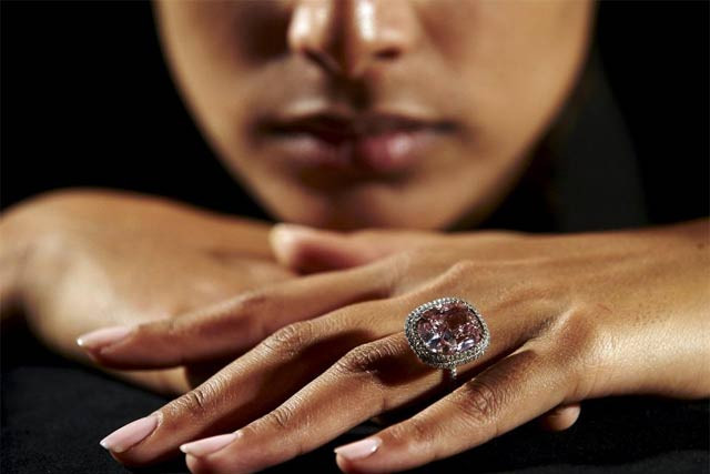 an employee poses with a cushion shaped 16 08 carat vivid pink diamond at christie 039 s auction house in geneva switzerland in this october 30 2015 file photo it fetched 28 725 million swiss francs 28 55 million on november 10 2015 the star lot of christie 039 s semi annual jewelry sale in geneva where designer eye candy drew strong prices photo reuters an employee poses with a cushion shaped 16 08 carat vivid pink diamond at christie 039 s auction house in geneva switzerland in this october 30 2015 file photo it fetched 28 725 million swiss francs 28 55 million on november 10 2015 the star lot of christie 039 s semi annual jewelry sale in geneva where designer eye candy drew strong prices photo reuters