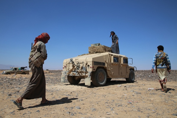 armed yemeni tribesmen supporting forces loyal to yemen 039 s saudi backed president abedrabbo mansour hadi stand next to an armoured vehicle in the area of sirwah west of marib city on november 8 2015 photo afp