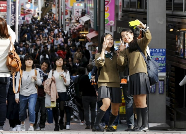 school girls pose for a selfie in the trendy harajuku district in tokyo japan november 11 2015 photo reuters school girls pose for a selfie in the trendy harajuku district in tokyo japan november 11 2015 photo reuters