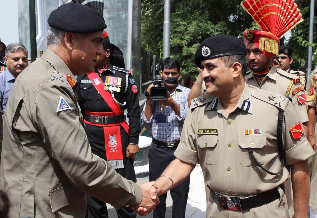 dg punjab rangers shakes hand with the indian bsf official at wagah border photo afp