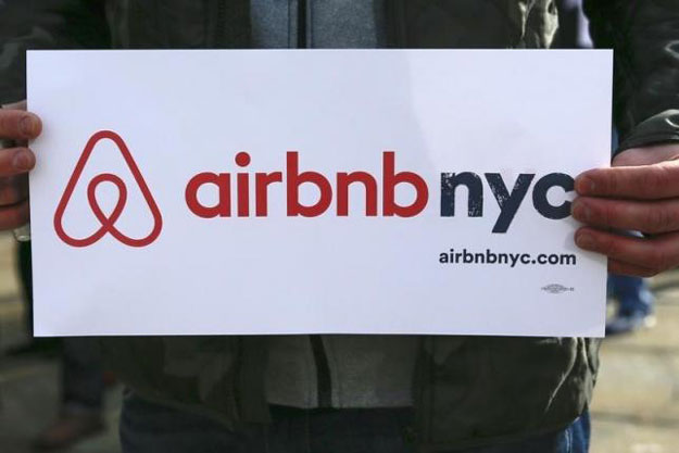 a supporter of airbnb holds a sign during a rally before a hearing called 039 039 short term rentals stimulating the economy or destabilizing neighborhoods 039 039 at city hall in new york january 20 2015 photo reuters