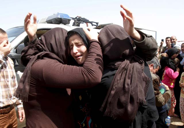 members of the minority yazidi sect who were newly released hug each other on the outskirts of kirkuk april 8 2015 photo reuters