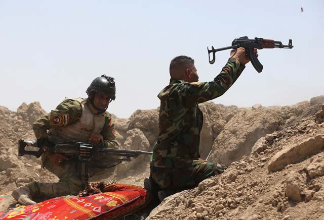 iraqi soldiers fire towards islamic state is group positions in the garma district of anbar province west of the iraqi capital baghdad on may 19 2015 photo afp