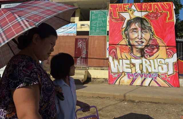 people walk past a graffiti depiction of myanmar 039 s opposition leader aung san suu kyi outside the headquarters of the national league for democracy party nld in yangon on november 13 2015 photo afp people walk past a graffiti depiction of myanmar 039 s opposition leader aung san suu kyi outside the headquarters of the national league for democracy party nld in yangon on november 13 2015 photo afp