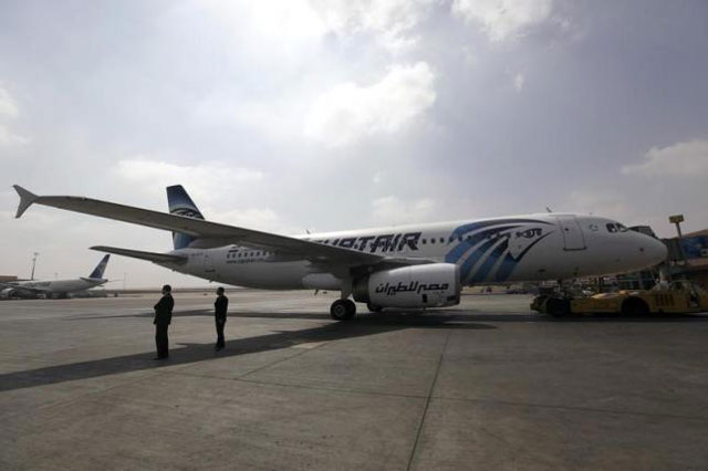airport staff stand next to an egyptair plane on the runway at cairo airport september 5 2013 photo reuters