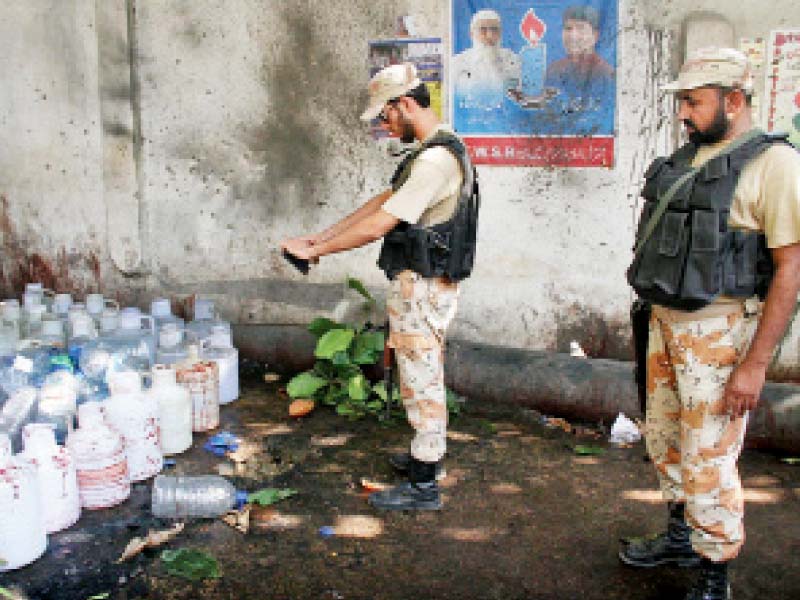 rangers soldiers collect evident from the site after a hand grenade attack near the water pumping station at khadda market lyari photo online