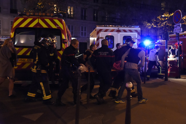 rescuers workers evacuate victims near the bataclan concert hall in central paris on november 13 2015 a number of people were killed and others injured in a series of gun attacks across paris as well as explosions outside the national stadium where france was hosting germany photo afp