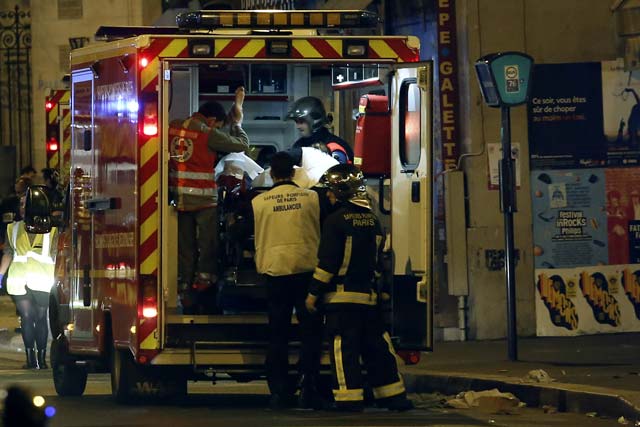 rescue workers evacuate victims near la belle equipe rue de charonne at the site of an attack on paris on november 14 2015 after a series of gun attacks occurred across paris as well as explosions outside the national stadium where france was hosting germany photo afp