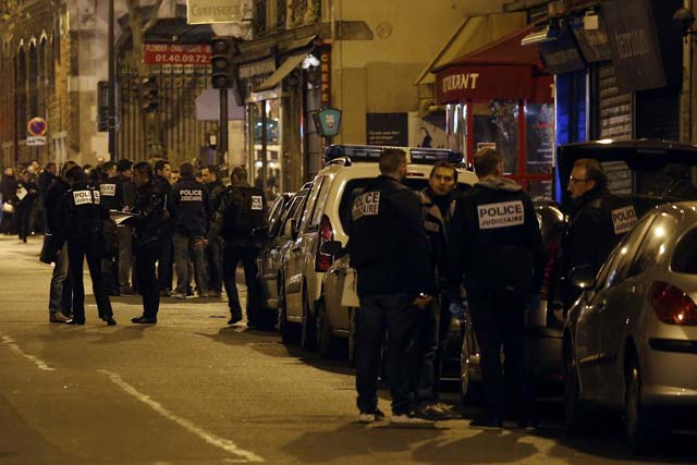 the criminal police arrive at the site of an attack on paris near la belle equipe rue de charonne on november 14 2015 after a series of gun attacks occurred across paris as well as explosions outside the national stadium where france was hosting germany photo afp