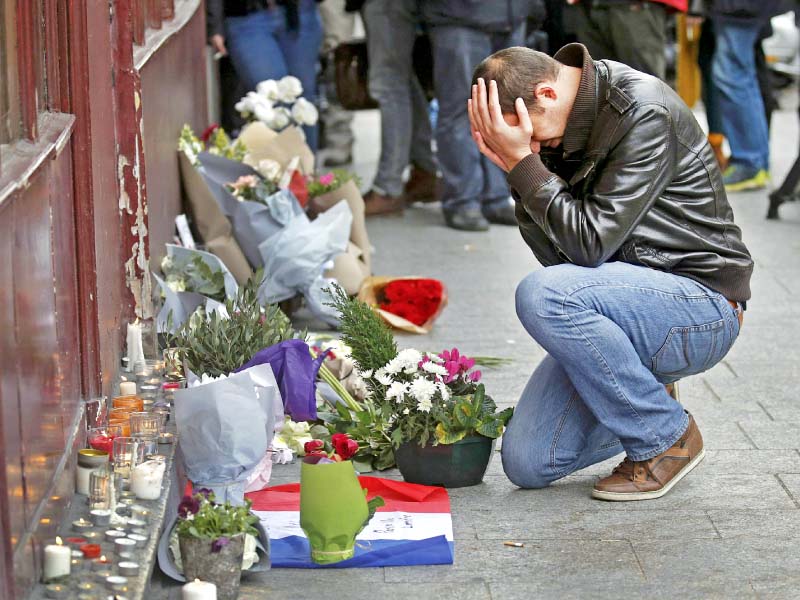 a man pays his respect outside the le carillon restaurant in paris photo reuters