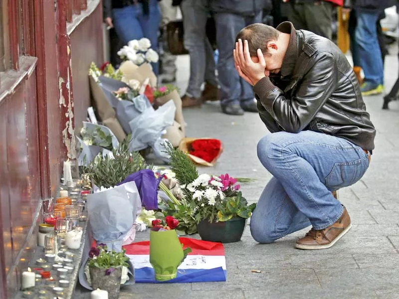 a man pays his respect outside the le carillon restaurant in paris photo reuters a man pays his respect outside the le carillon restaurant in paris photo reuters