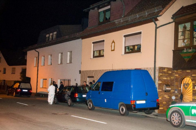 investigation officers and a hearse stand in front of a house where police found the bodies of eight babies in an apartment in wallenfels southern germany on november 12 2015 photo afp investigation officers and a hearse stand in front of a house where police found the bodies of eight babies in an apartment in wallenfels southern germany on november 12 2015 photo afp