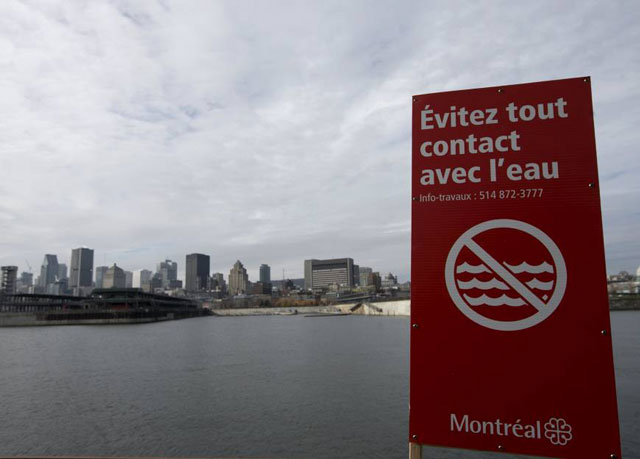 a sign reading 039 don 039 t touch the water 039 stands beside the st lawrence river in montreal after the city began dumping raw sewage into the river photo reuters