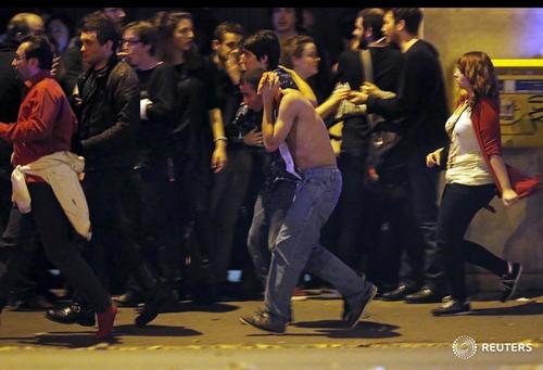 an injured man holds his head as people gather near the bataclan concert hall following fatal shootings in paris france november 13 2015 photo reuters