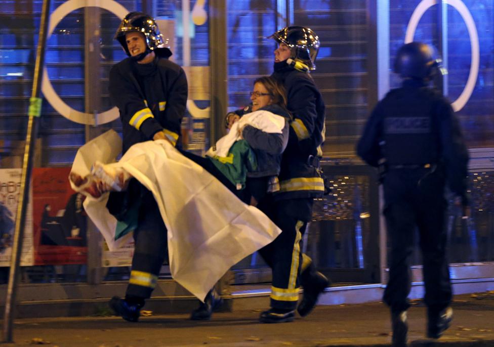 french fire brigade members aid an injured individual near the bataclan concert hall following fatal shootings in paris france november 13 2015 photo reuters