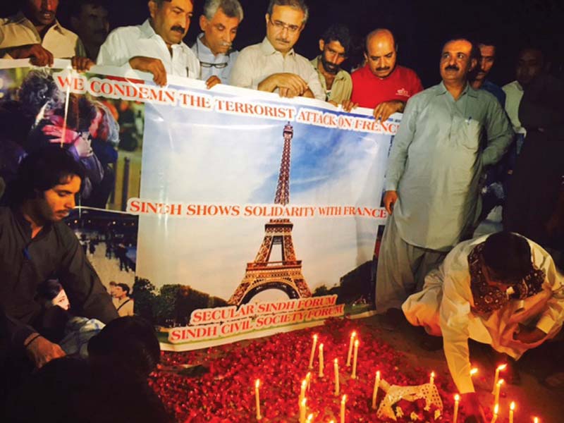 human rights activists and political workers hold a candlelight vigil to showing solidarity with the victims of the paris attack on sunday photo courtesy sindh secular forum