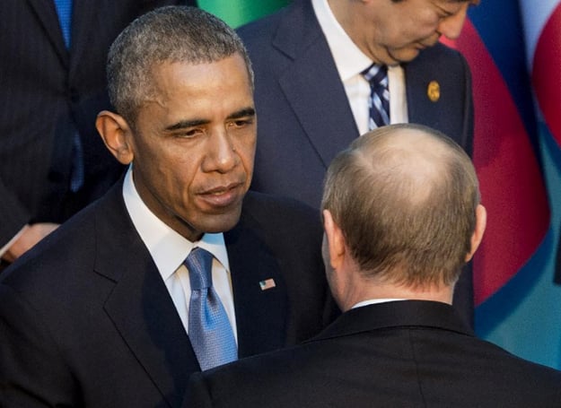 us president barack obama left talks with his russian counterpart vladimir putin as they arrive for the official photo ahead of the g20 summit in antalya turkey on november 15 2015 photo afp