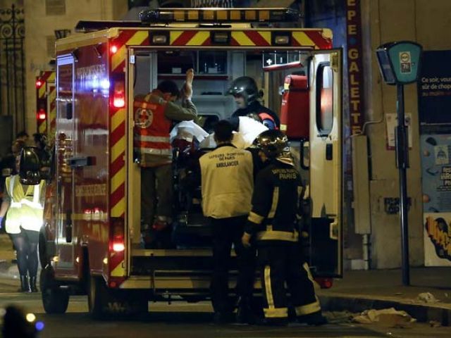 rescue workers evacuate victims near la belle equipe rue de charonne at the site of an attack on paris on november 14 2015 after a series of gun attacks occurred across paris as well as explosions outside the national stadium where france was hosting germany photo afp