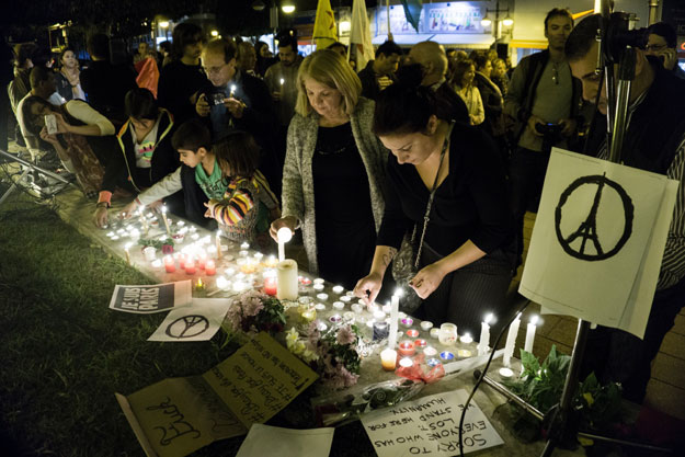 people take part in a candlelight vigil organised by the french cultural institute alliance francaise in the cypriot port city of limassol on november 15 2015 in solidarity with the victims of coordinated attacks in paris photo afp