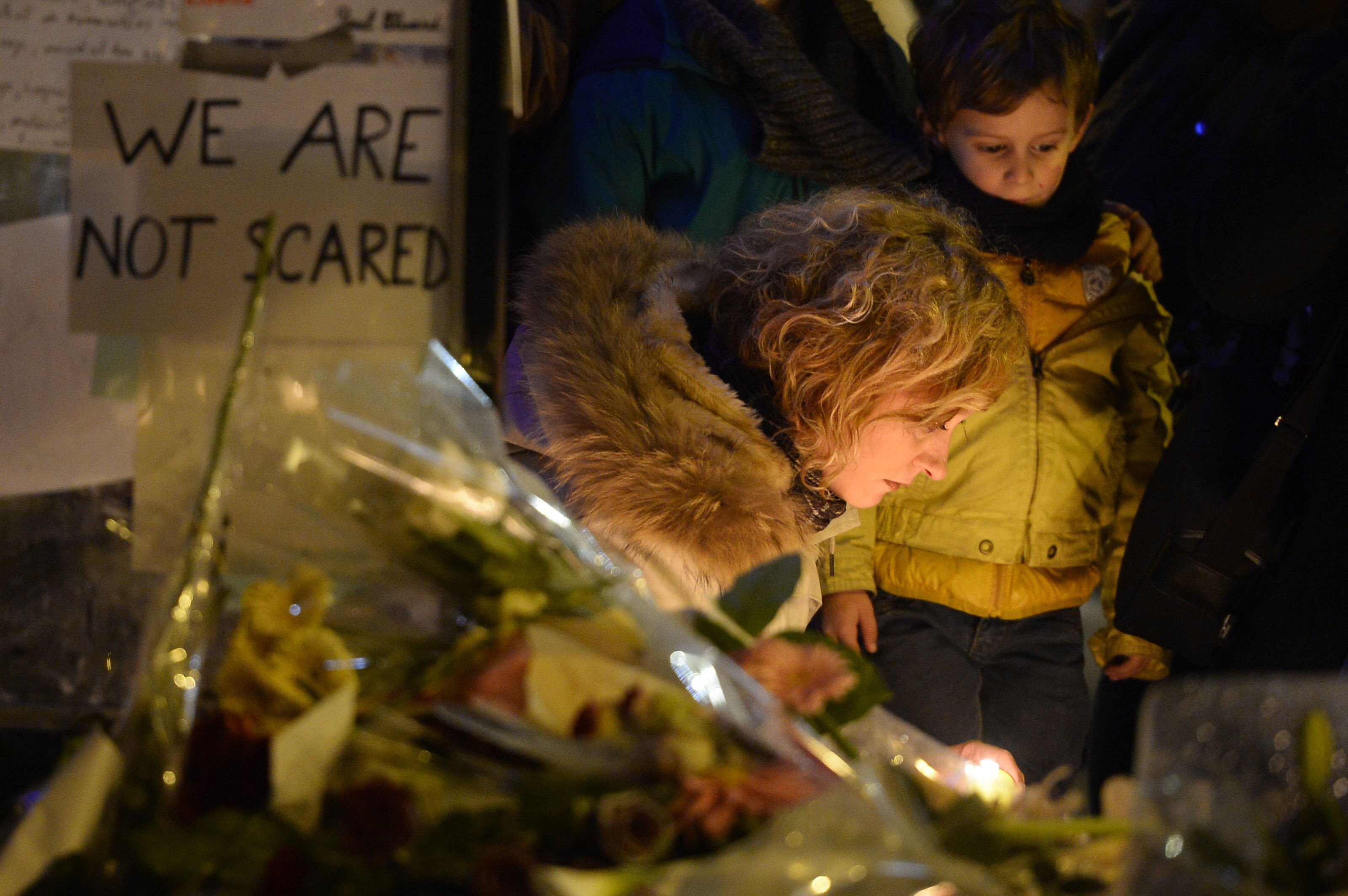 people gather at a makeshift memorial site on november 15 2015 outside the la belle equipe cafe rue de charonne for victims of the november 13 attacks in paris the string of coordinated attacks in and around paris late friday left more than 120 people dead in the worst such violence in france 039 s history the assailants struck six different sites including the stade de france football stadium and eateries in the trendy east of the city photo afp