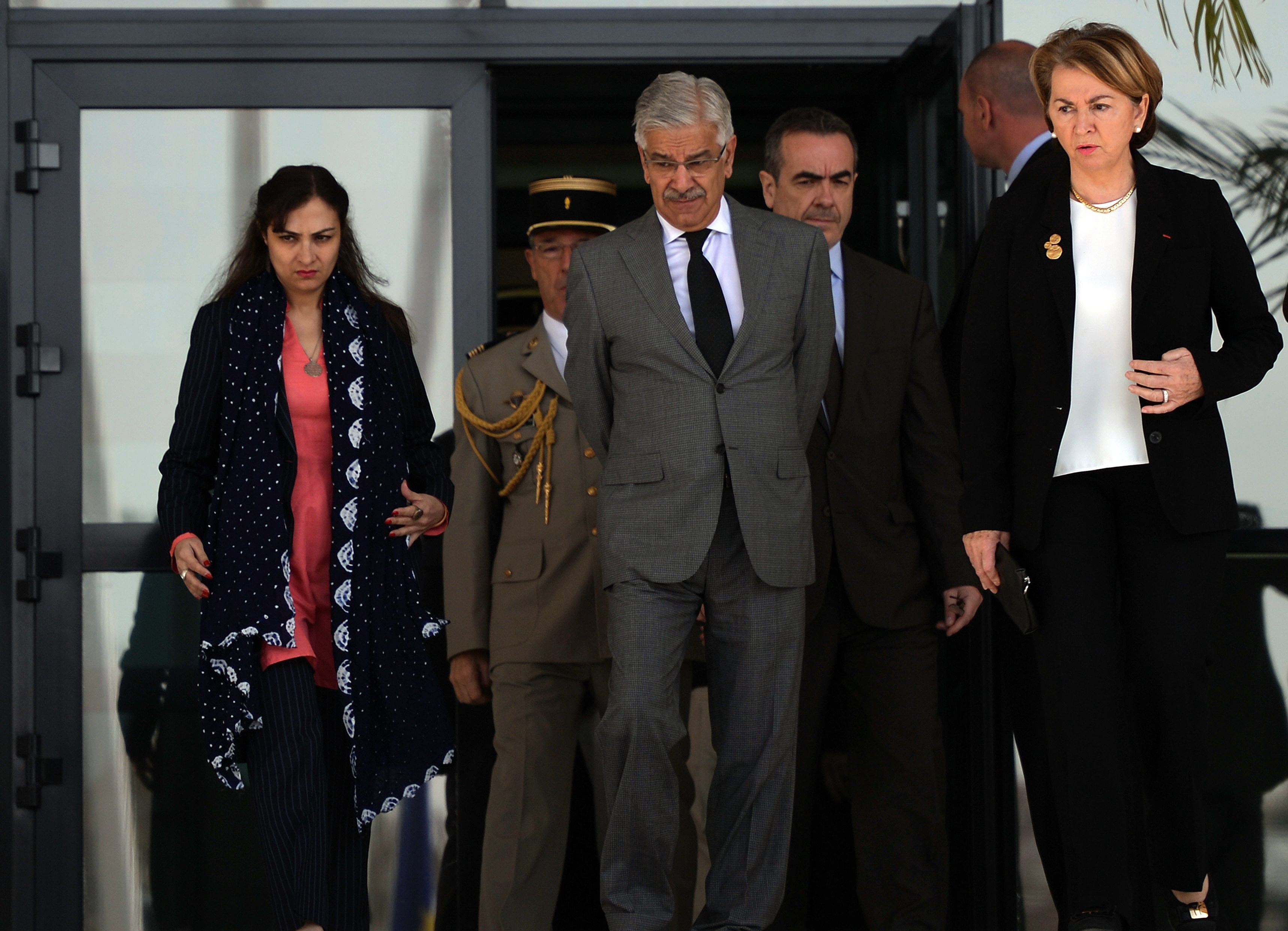 martine dorance r and khawaja asif c arrive to attend a minute of silence in tribute to victims of the november 13 paris attacks at the french embassy in islamabad on november 16 2015 photo afp