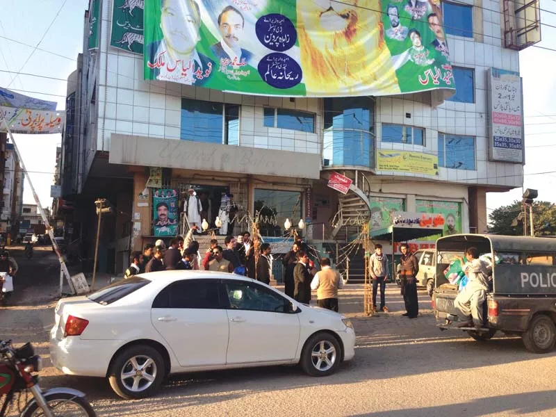 administration officials stand outside a plaza displaying a large banner in pwd islamabad photo express administration officials stand outside a plaza displaying a large banner in pwd islamabad photo express