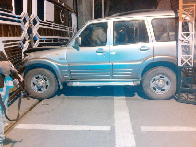 a security official stands near the vehicle that rammed into pakistani gate on wagha border photo nni a security official stands near the vehicle that rammed into pakistani gate on wagha border photo nni