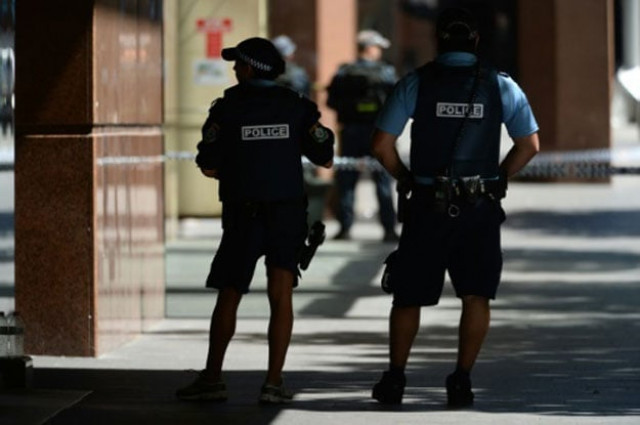 armed police are seen near a cafe in the central business district of sydney photo afp armed police are seen near a cafe in the central business district of sydney photo afp